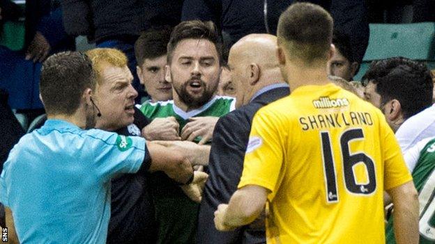 Hibernian and Morton players and managers become involved in a melee