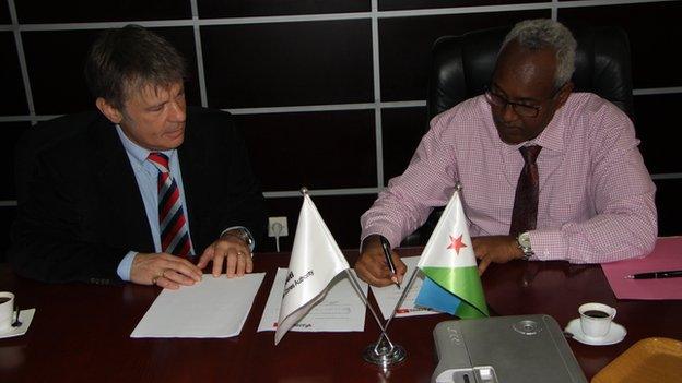 Bruce Dickinson signing a memorandum of understanding with Aboubaker Omar Hadi, chairman of the Djibouti Ports and Free Zone Authority