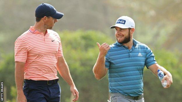 Rory McIlroy talking to Tyrell Hatton during their round