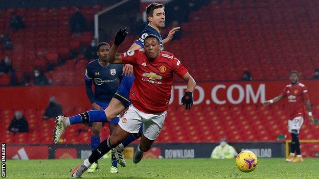 Jan Bednarek fouls Anthony Martial