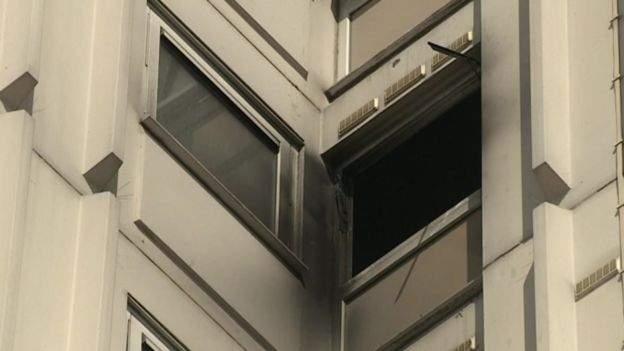 Smoke-damaged windows after tower block fire