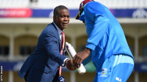 Michael Holding shakes hands with Jason Holder