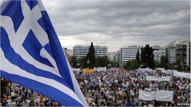 Greek flag and protesters