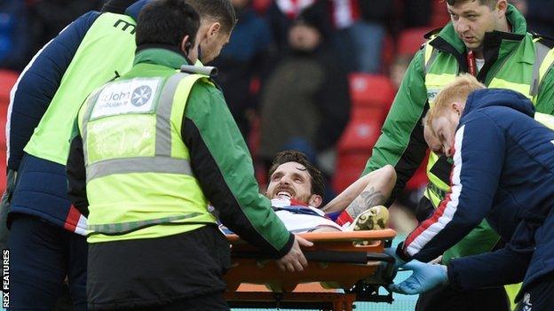 Joe Allen leaves on a stretcher