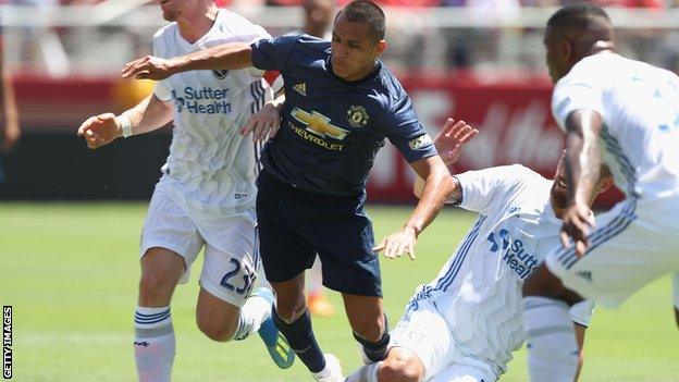 Alexis Sanchez rides a tackle against San Jose Earthquakes