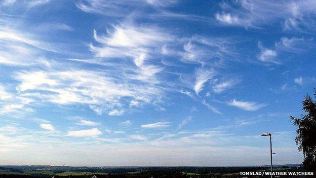 Cirrus uncinus over country landscape