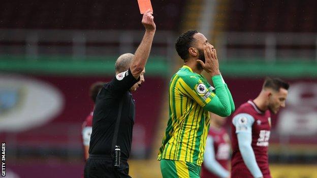 West Brom defender Semi Ajayi is shown a red card by referee Mike Dean