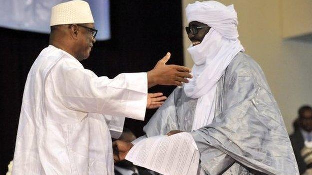 Mali"s President Ibrahim Boubacar Keita (L) embrasses Mahamadou Djery Maiga (R), the vice-president and spokesman of the Transitional Council of the State of Azawad, following the signing of the ammended version of the Algerian Accord on June 20, 2015 in Bamako.