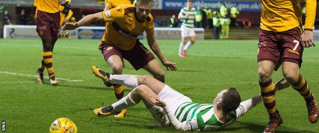 Celtic midfielder Callum McGregor wins a penalty after going down under the challenge of Motherwell's Andy Rose