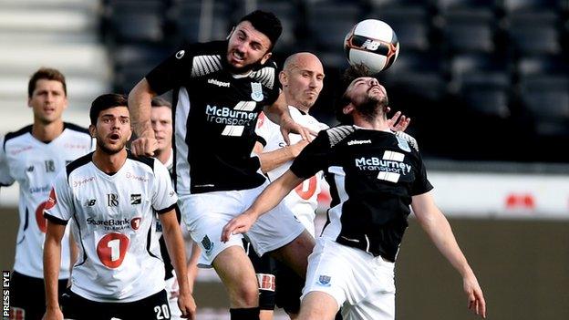 Joe McKinney and Michael Gault attempt to clear the ball for Ballymena