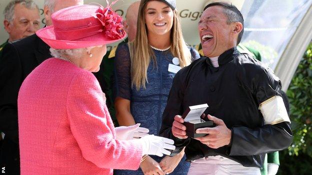 The Queen shares a joke with Frankie Dettori during the presentation of his winner's medal