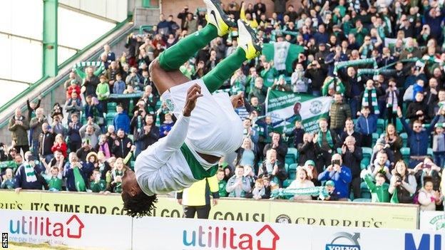 Hibs defender Efe Ambrose does a somersault to celebrate their promotion