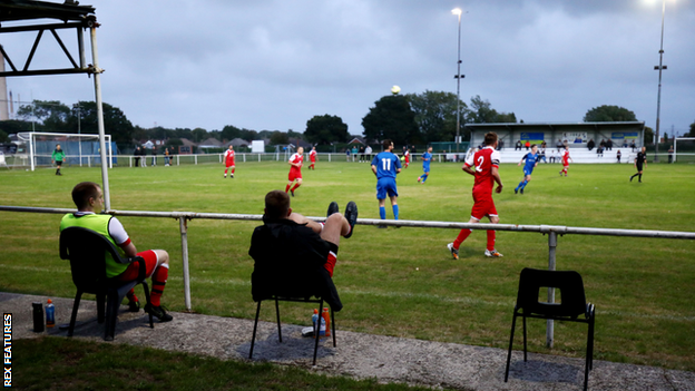 Substitutes social distance during the first half of the pre-season friendly match between Fawley AFC and Stockbridge