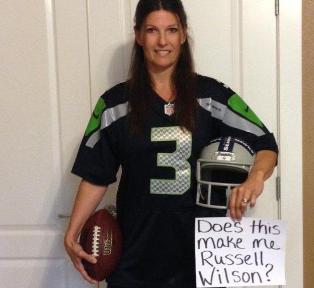 A woman dressed as an American football player with a message reading 'does this make me Russell Wilson?'