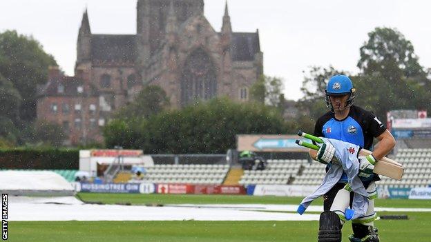 Worcestershire's Ben Cox runs in the rain