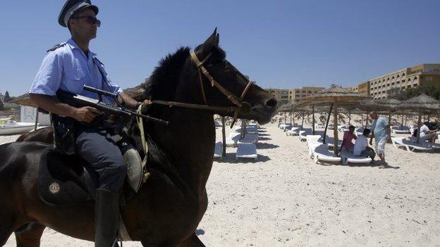 Policeman on horse on beach