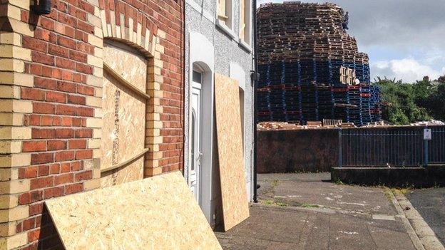 Housing Executive workers spent Friday morning putting up boards to protect windows and doors