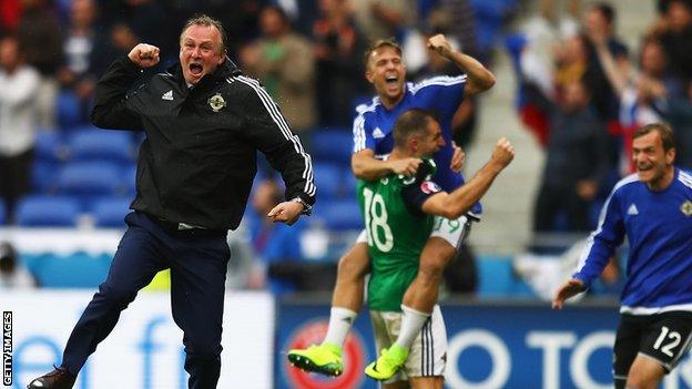 Michael O'Neill celebrates with his NI players after the Euro 2016 victory over Ukraine