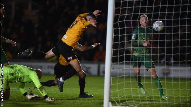 Newport striker Padraig Amond turns in the rebound after his penalty had been saved