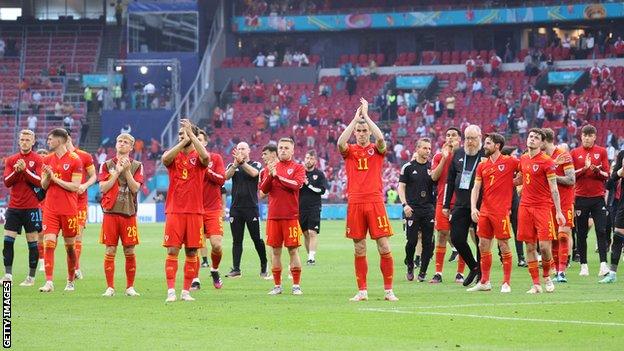 Wales' players applaud their fans