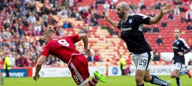 Gary Harkins (right) sends Adam Rooney tumbling in the box to concede a late penalty and earn a red card