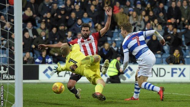 Luke Freeman of QPR scores a goal past Brentford goalkeeper Daniel Bentley