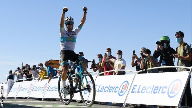 Astana's Alexey Lutsenko raises his arms in celebration after winning stage six of the 2020 Tour de France