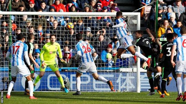 Steve Mounie rises to head home