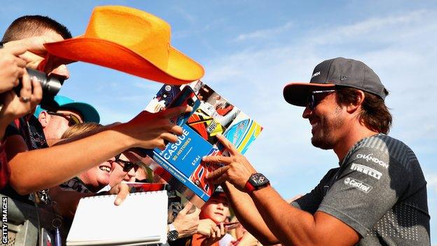 Fernando Alonso signs autographs