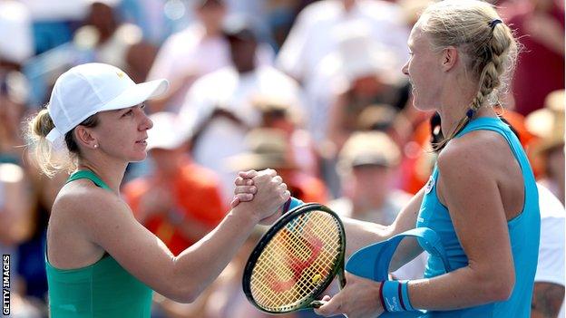 Simona Halep and Kiki Bertens shake hands at the net