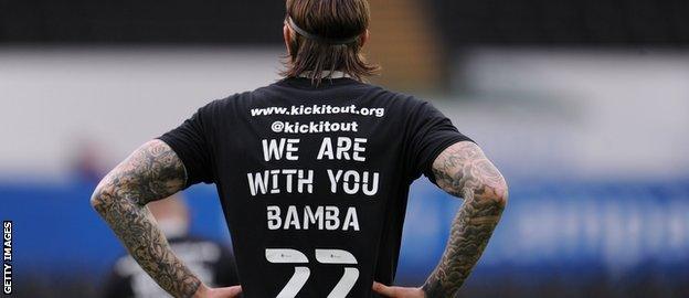 Aden Flint wears a shirt with 'We are with you Bamba 22' on it