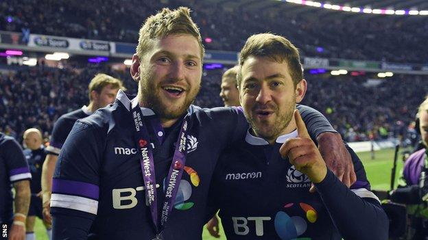 Finn Russell and Greig Laidlaw celebrate victory over England