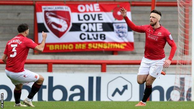 Cole Stockton celebrates scoring Morecambe's first goal against Solihull Moors in the FA Cup second round