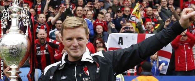 Eddie Howe, manager of Bournemouth poses with the trophy after winning the Championship