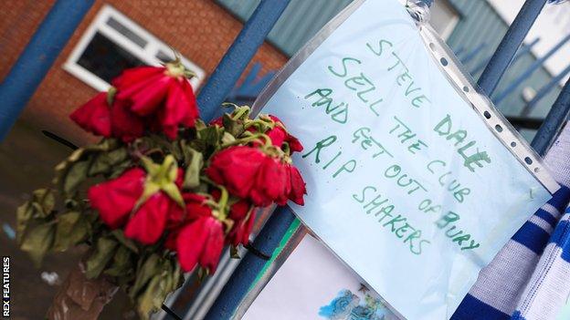 Bury fans lay roses at Gigg Lane