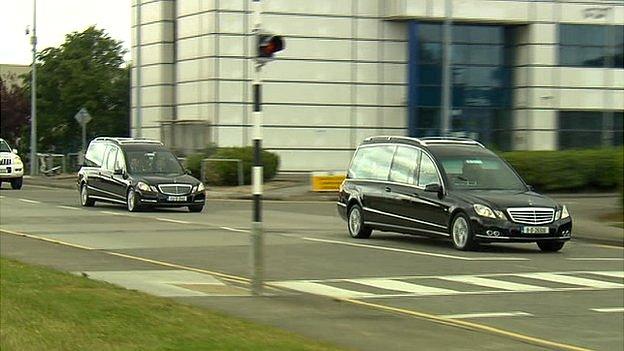 Hearses leave airport