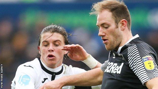Conor Gallagher of Swansea City and Derby County's Matthew Clarke compete for the ball