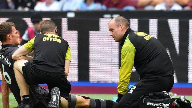 Christoph Zimmermann receives treatment from Norwich physios before being forced off against West Ham