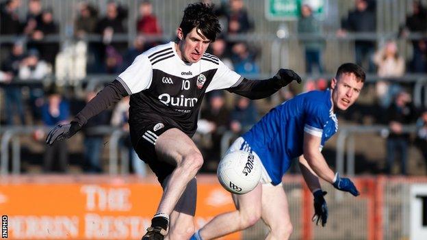 Eugene Branagan gets in a shot for Kilcoo after brushing past Eunan Doherty