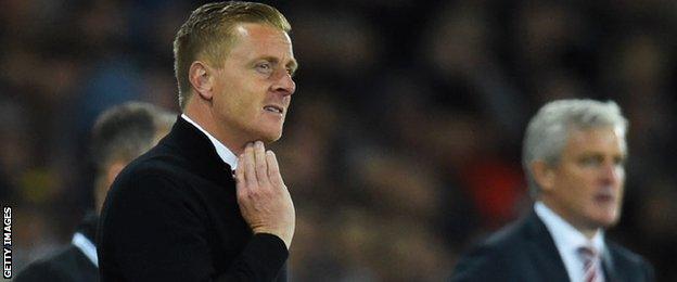 Swansea City manager Garry Monk alongside Stoke City boss Mark Hughes