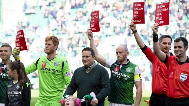 Hibs players with Show Racism the Red Card placards