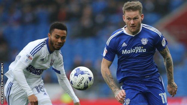 Cardiff City's Aron Gunnarsson wins the ball from Grant Ward