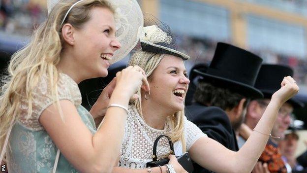 Racegoers cheering on runners in the Queen's Vase