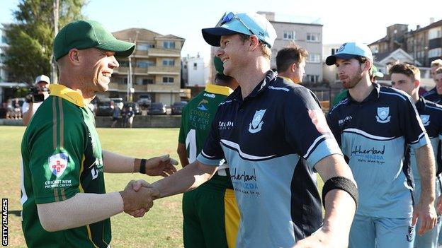 David Warner and Steve Smith shake hands during a domestic cricket game in Australia in November