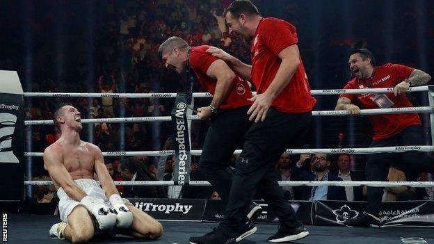 Smith's brothers and trainer Joe Gallagher rushed to join him in the ring when the stoppage arrived