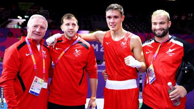 Team Wales boxing head coach Colin Jones (L) celebrates with Garan Croft (2nd R) after the light-middleweight's last-16 win over Nigeria's Abdul-Afeez Osoba