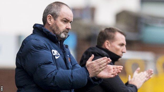 Steve Clarke applauds his Kilmarnock side as Celtic boss Brendan Rodgers looks on