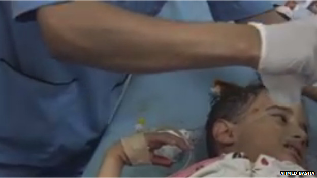 A doctor treating a small child, who is injured