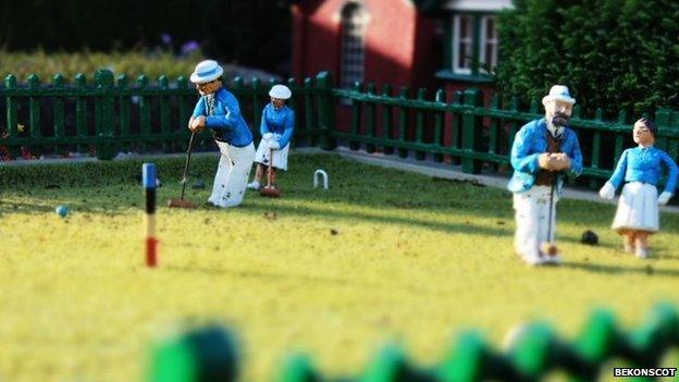 Model figures playing croquet