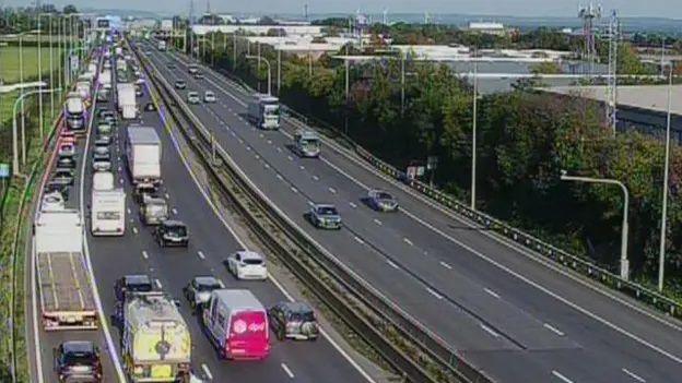 An image taken above a motorway with traffic at standstill on the northbound carriageway